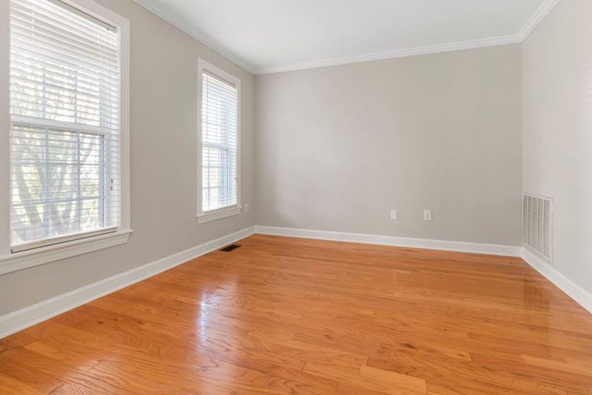 A sparsely furnished room with a single chair and clear surfaces